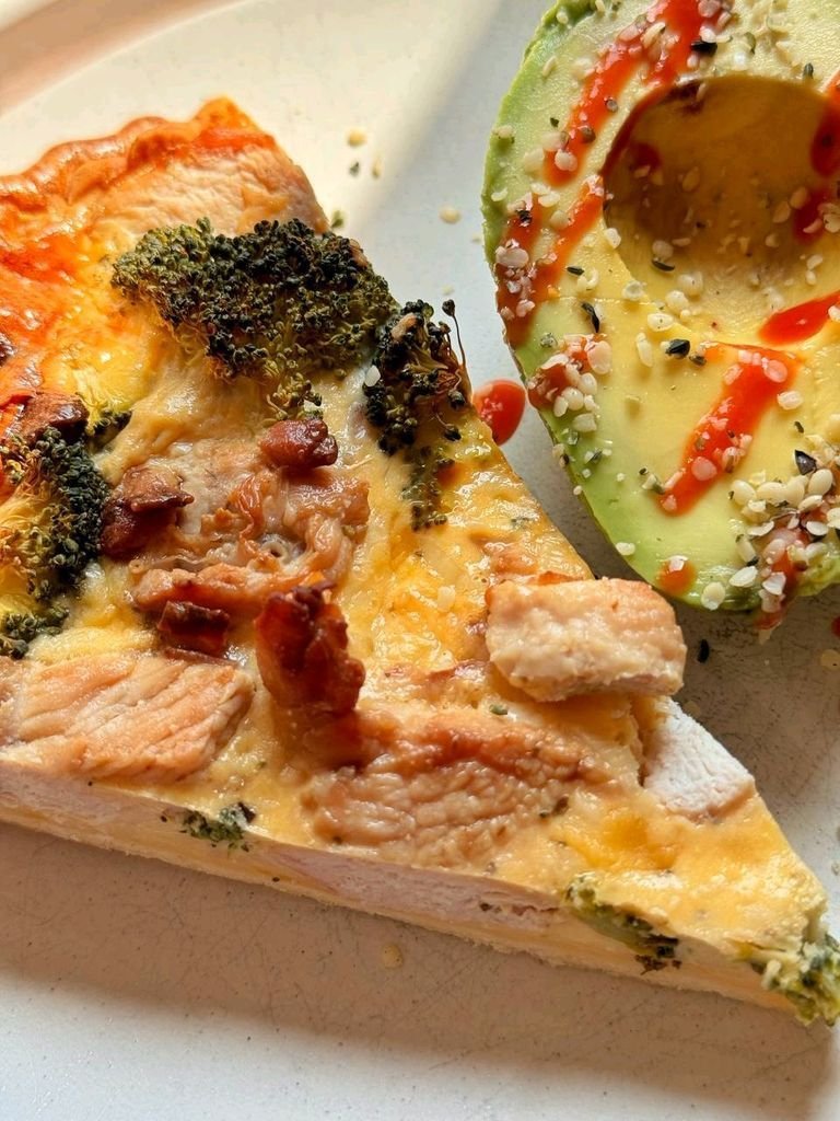 Quiche with avocado, seeds, and spicy sauce