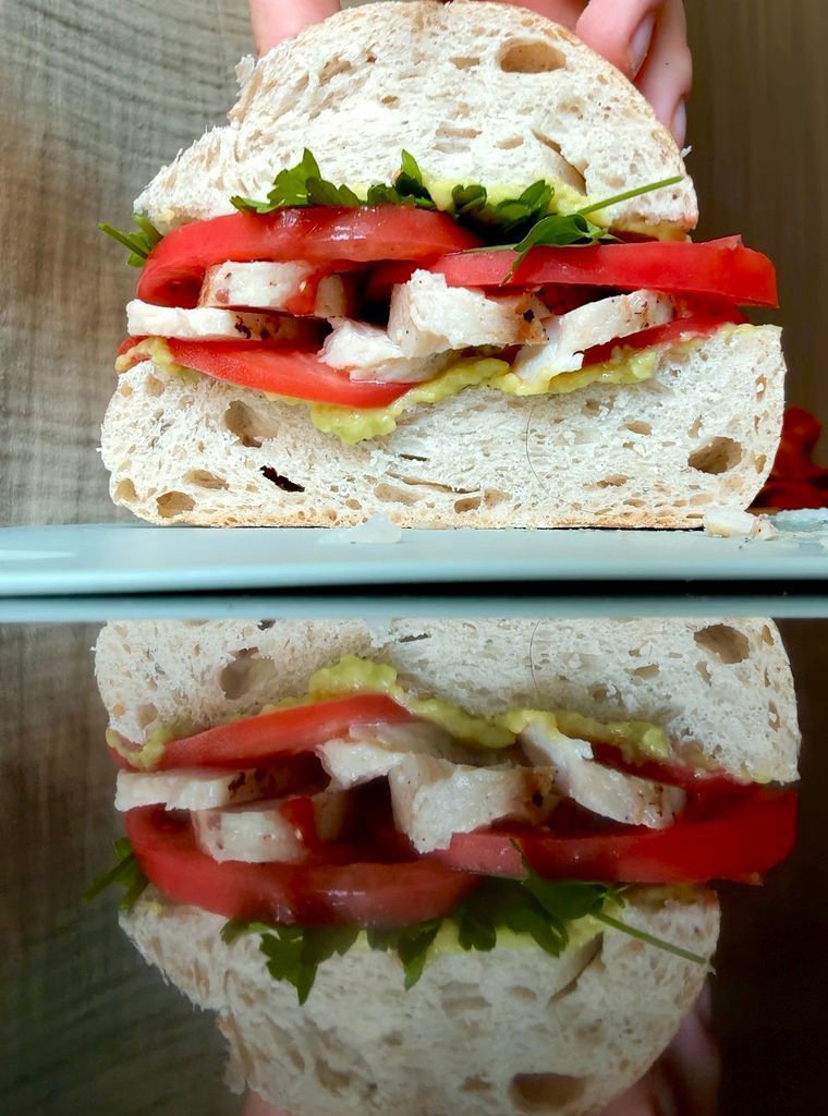 Toast with ham, avocado spread, tomato