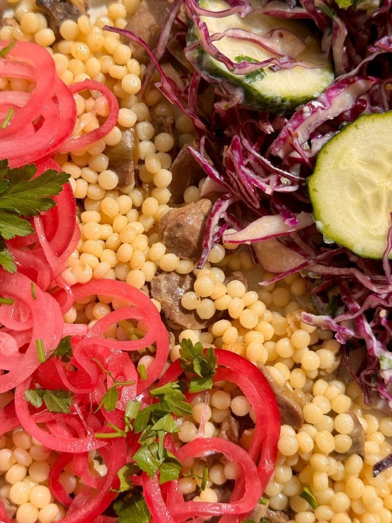 Ptitim with chicken hearts and cabbage salad