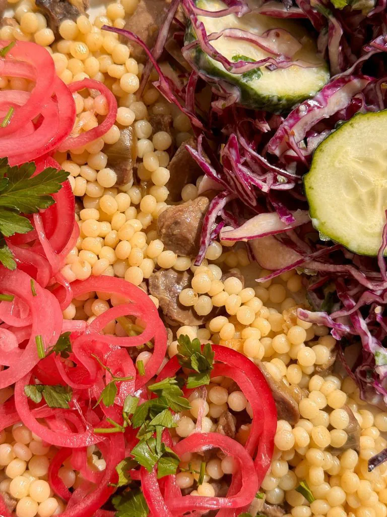 Ptitim with chicken hearts and cabbage salad
