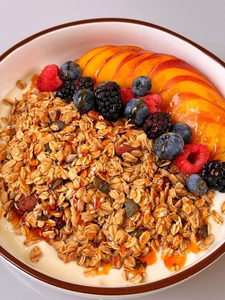 Granola with yogurt, fruit and maple syrup